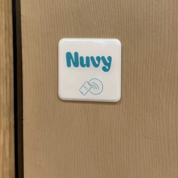Tag NFC Nuvy posé sur un pilier au comptoir
